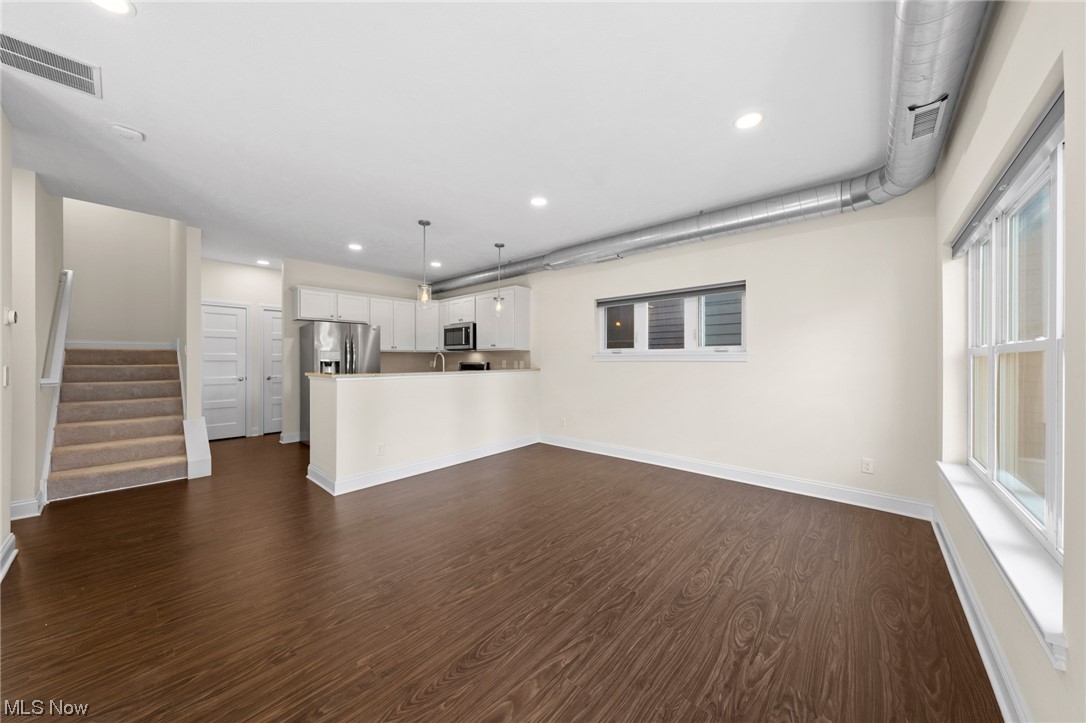 1943 Randall Road Cleveland, OH 44113 - Photo 15 of 40 Unfurnished living room with dark wood-type flooring