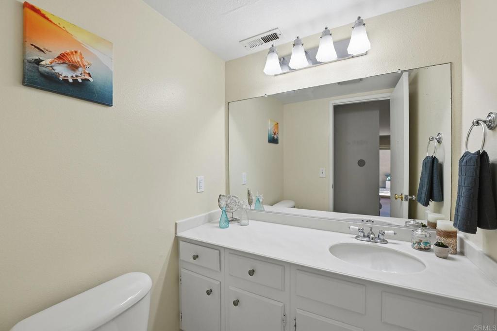 17 Cheyenne, Unit 64 Irvine, CA 92604 - Photo 13 of 33 a bathroom with a toilet a sink and mirror
