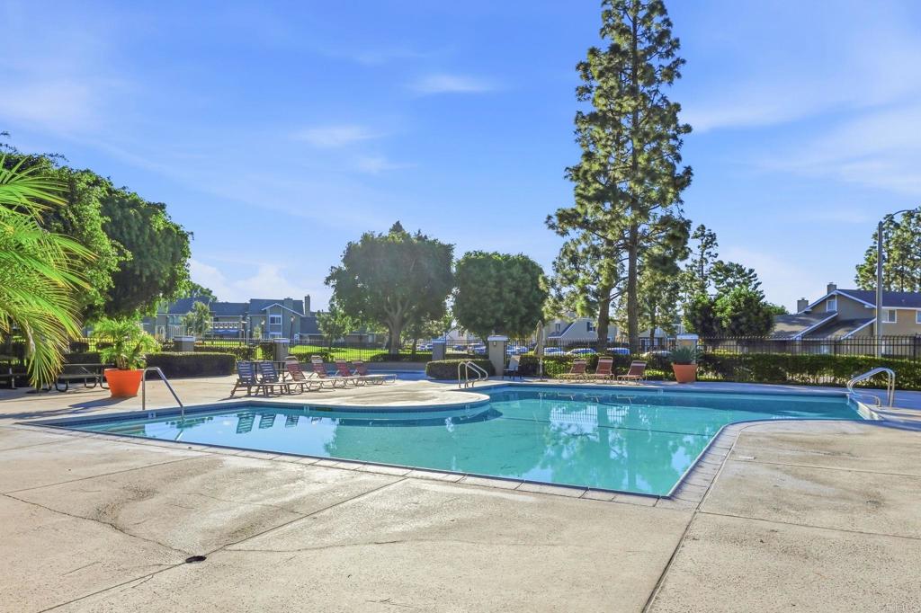 17 Cheyenne, Unit 64 Irvine, CA 92604 - Photo 29 of 33 a view of swimming pool with outdoor seating and trees in the background