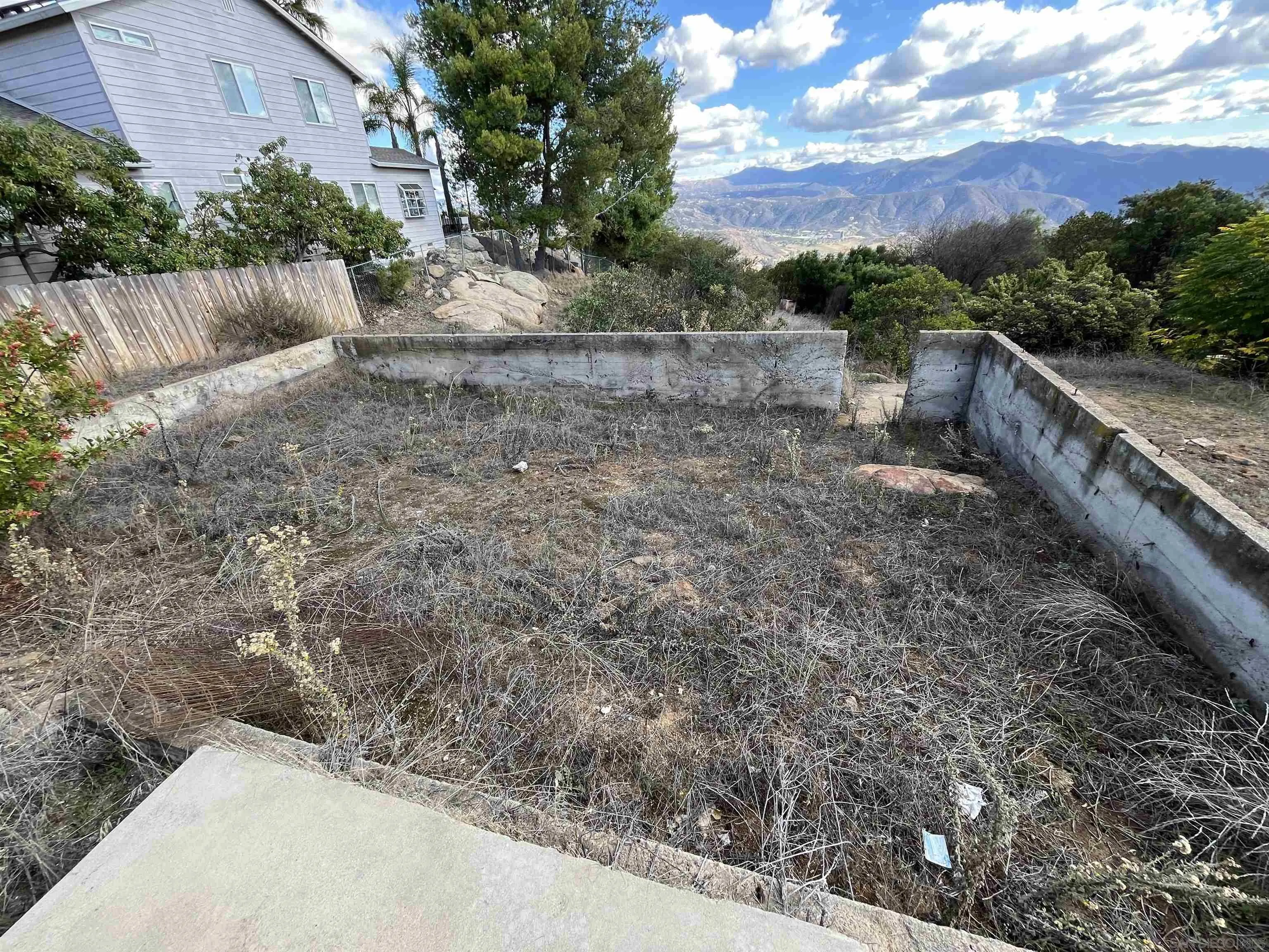 1828 Suncrest Boulevard, Unit 1828 El Cajon, CA 92021 - Photo 9 of 15 a view of a yard with wooden fence