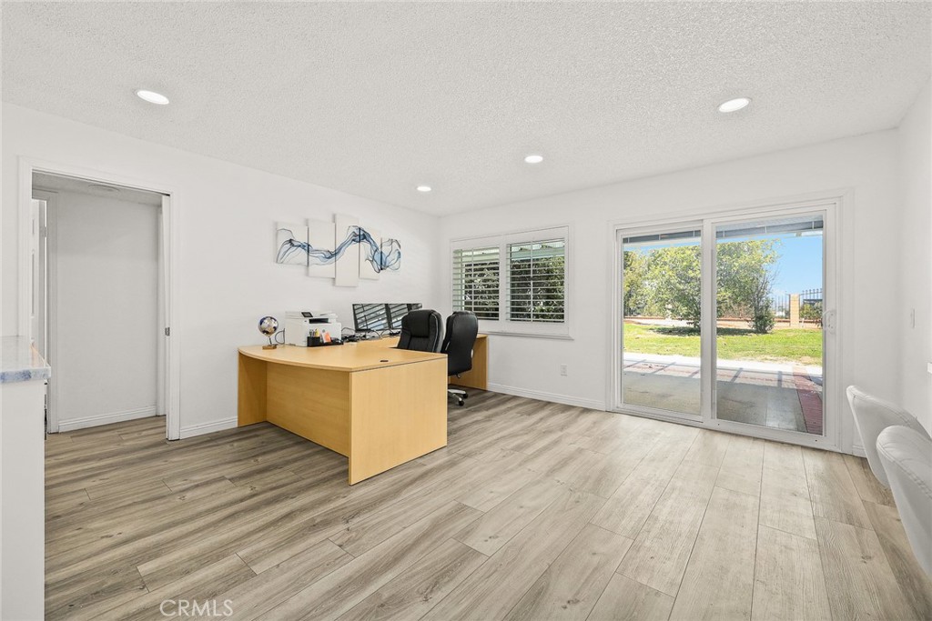 17845 Calle Barcelona Rowland Heights, CA 91748 - Photo 12 of 45 a view of a kitchen with kitchen island a sink wooden floor and a large window