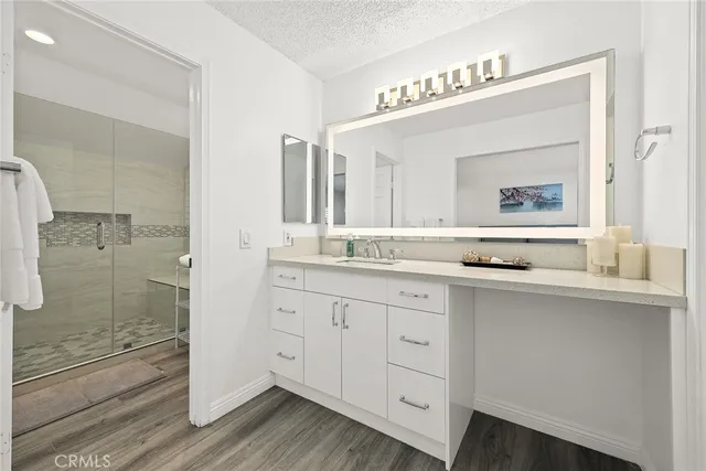 a bathroom with a granite countertop sink mirror and double