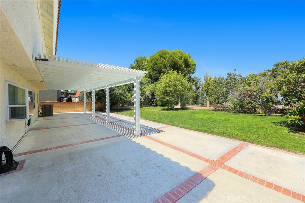 17845 Calle Barcelona Rowland Heights, CA 91748 - Photo 32 of 45 a view of a patio with a table and chairs under an umbrella