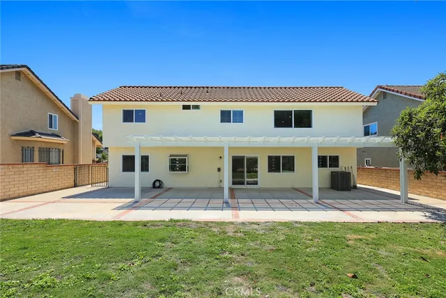 a backyard of a house with yard and outdoor seating