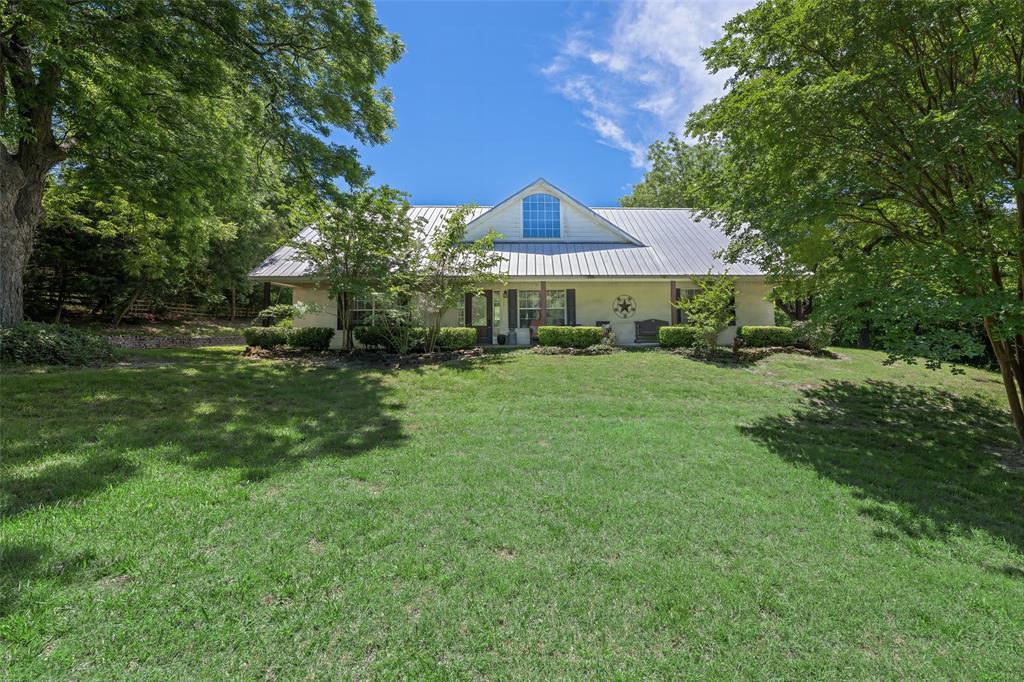 1000 Ballard Road Van Alstyne, TX 75495 - Photo 3 of 40 a view of a house next to a big yard and large trees