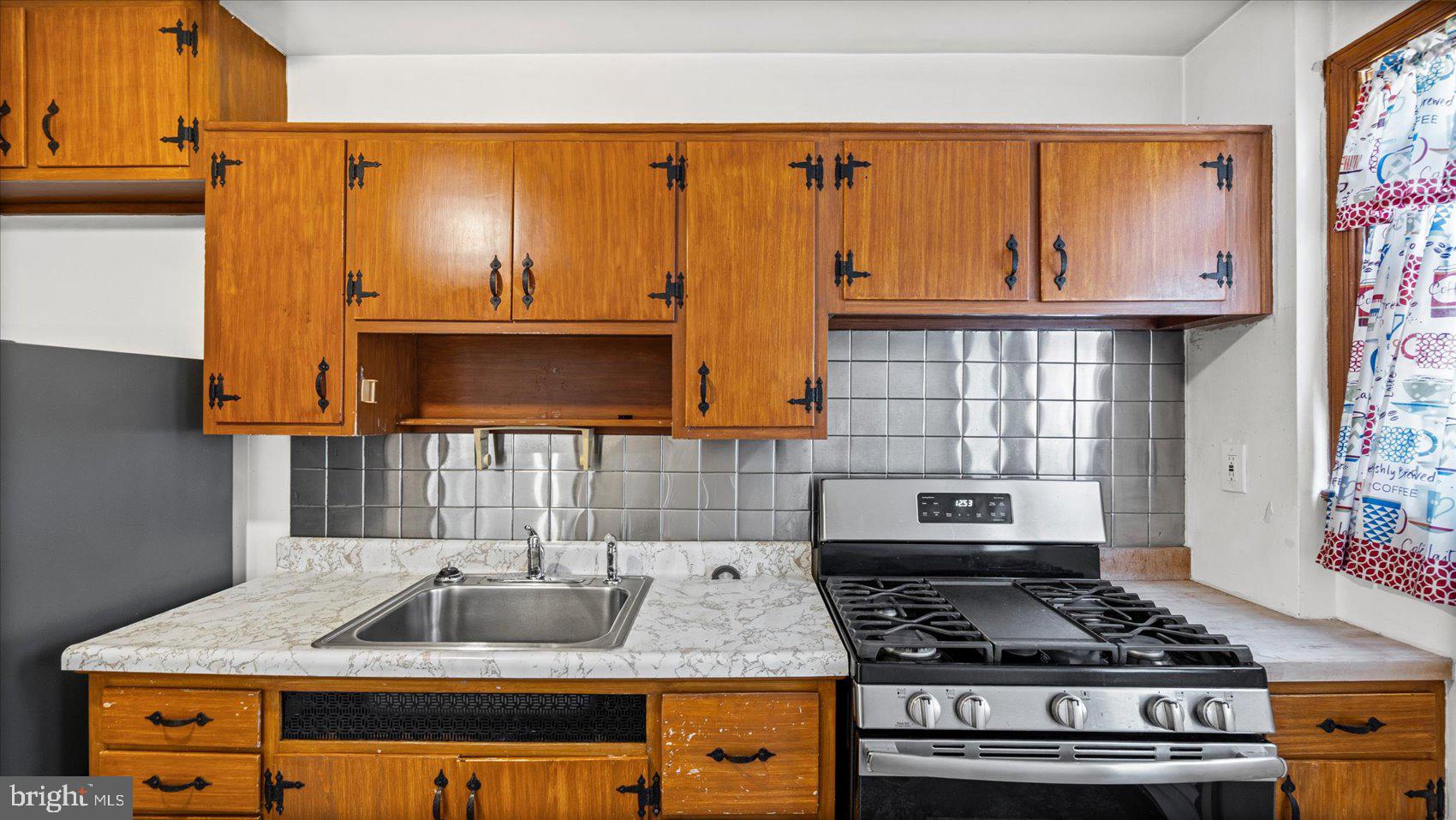 1805 Crestview Road Baltimore, MD 21239 - Photo 12 of 39 a kitchen with granite countertop a sink a stove and cabinets