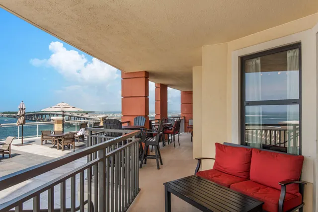 a balcony with a table and chairs