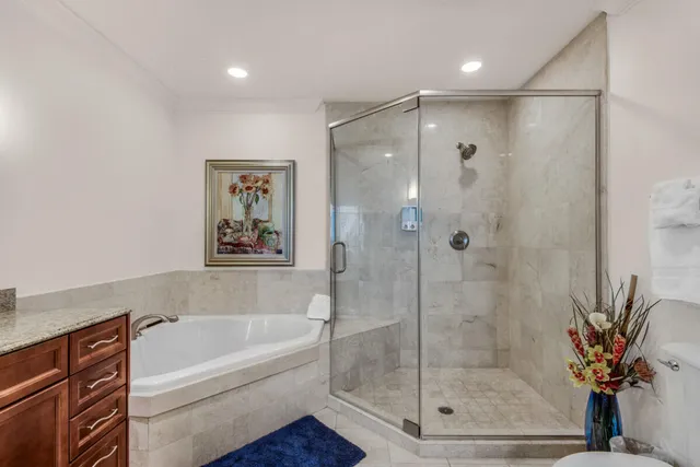 a bedroom with a bed a couch and dresser