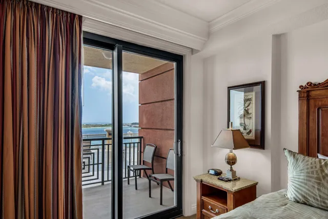 a living room with large windows and a couch