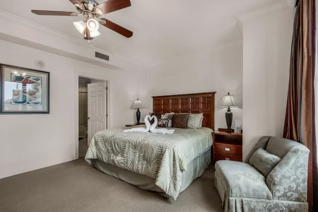 a living room with furniture a flat screen tv and a floor to ceiling window