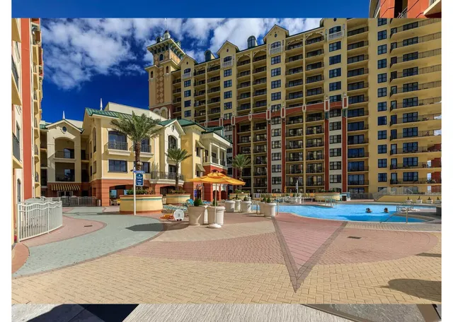 a view of a swimming pool with outdoor seating