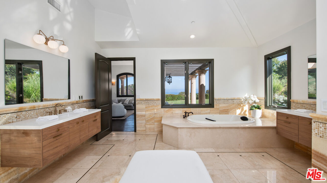 27311 Winding Way Malibu, CA 90265 - Photo 36 of 73 a large living room with stainless steel appliances furniture a large window and a couch