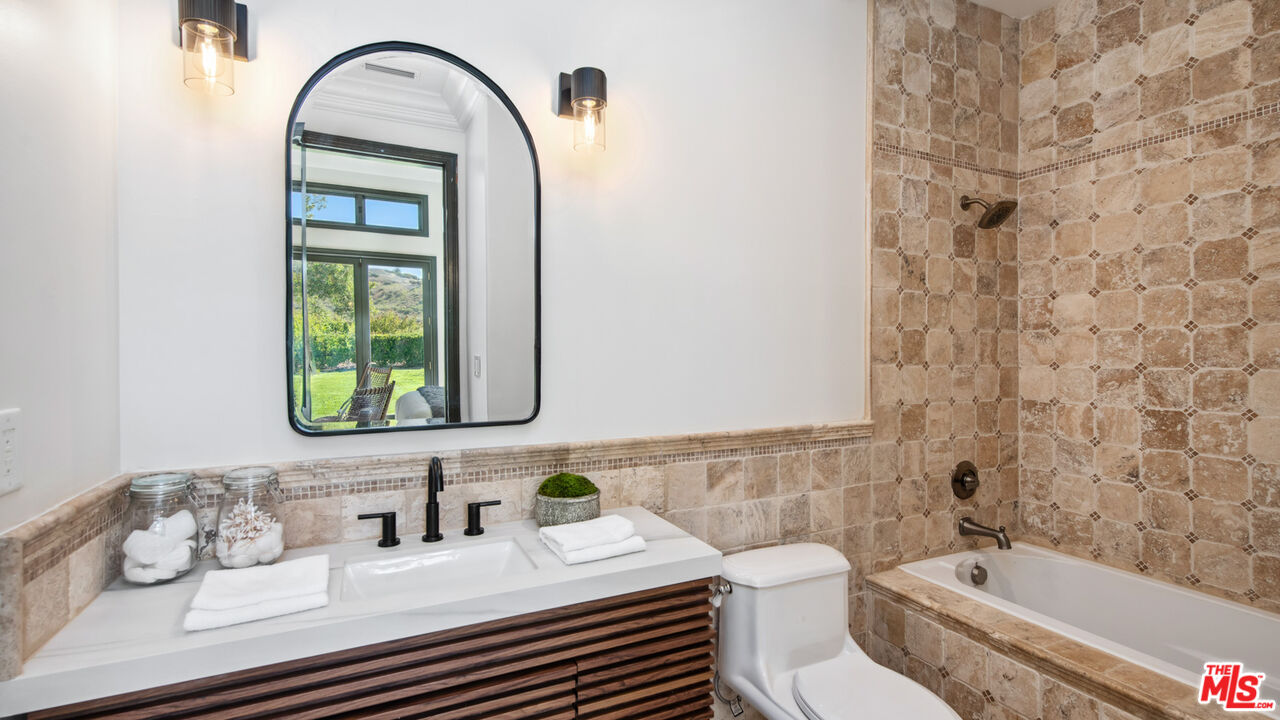 27311 Winding Way Malibu, CA 90265 - Photo 53 of 73 a bathroom with a sink a toilet and bathtub