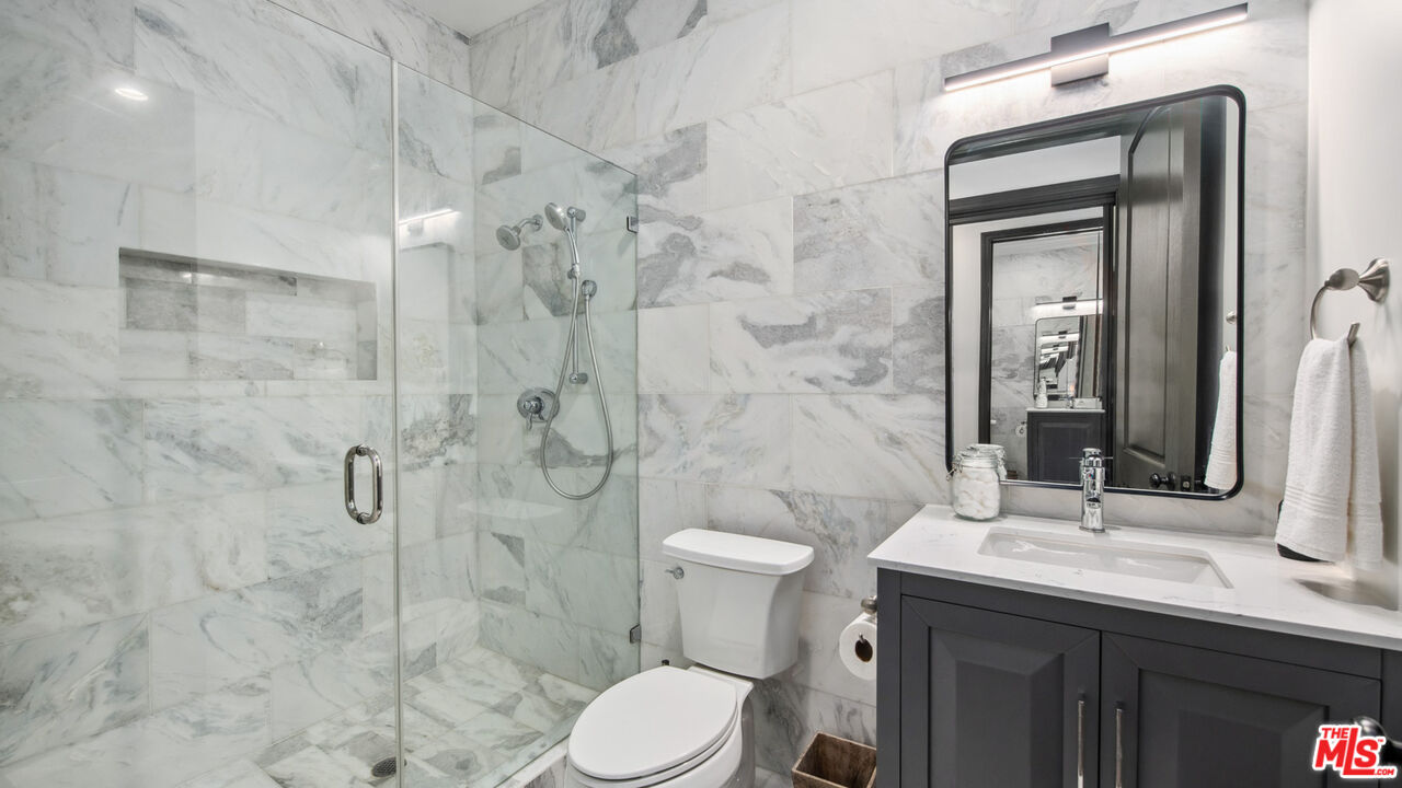 27311 Winding Way Malibu, CA 90265 - Photo 59 of 73 a bathroom with a sink a toilet and shower