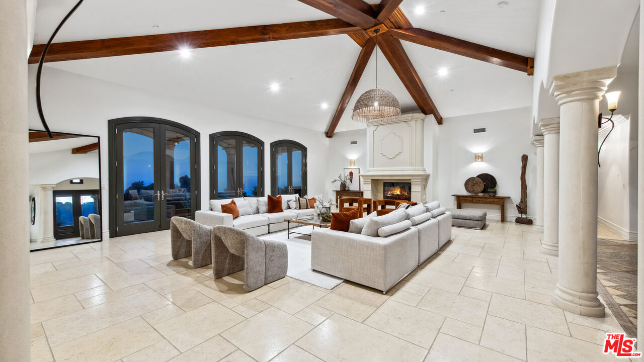 27311 Winding Way Malibu, CA 90265 - Photo 66 of 73 a living room with fireplace furniture and a large window