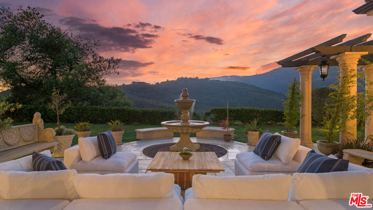 27311 Winding Way Malibu, CA 90265 - Photo 72 of 73 a view of a patio with couches chairs and a potted plant