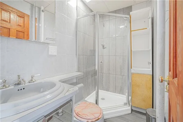 a bathroom with a sink toilet and shower