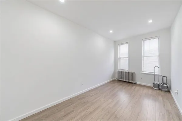 a view of room with window and wooden floor