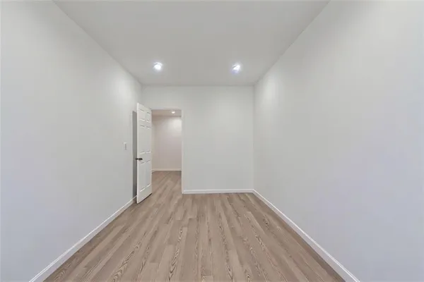a view of a room with wooden floor