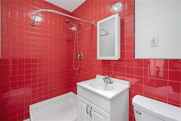 a bathroom with a sink toilet and shower