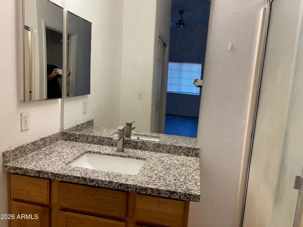 a white toilet sitting next to a white sink