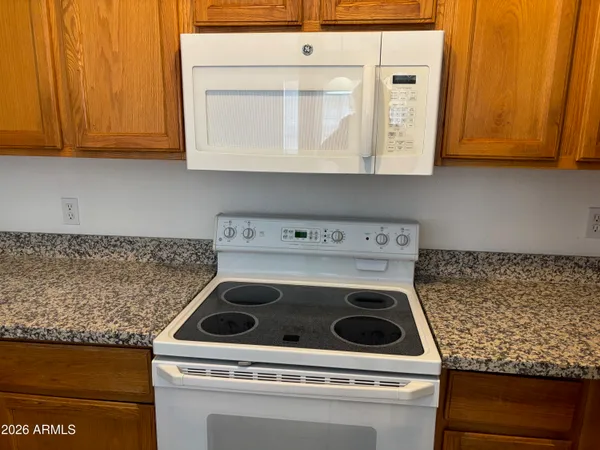 a stove top oven sitting inside of a kitchen