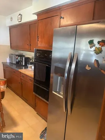 a kitchen with granite countertop a refrigerator and a stove