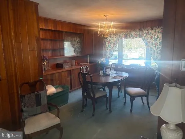 a view of a dining room with furniture and chandelier
