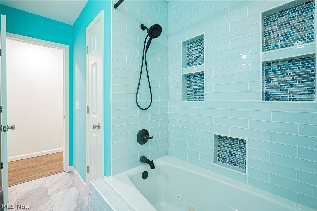 2055 Ganyard Road Akron, OH 44313 - Photo 20 of 49 Bathroom with wood-type flooring and tiled shower / bath