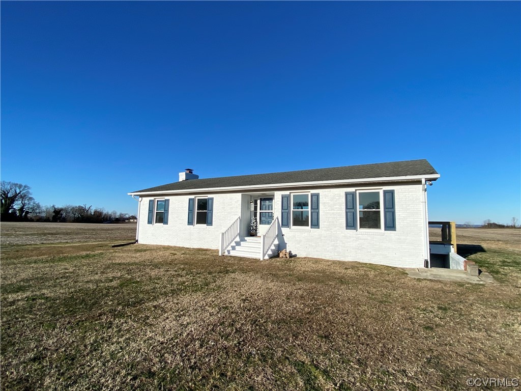 320 Courtney Road Lancaster, VA 22503 - Photo 1 of 43 a front view of a house with a yard