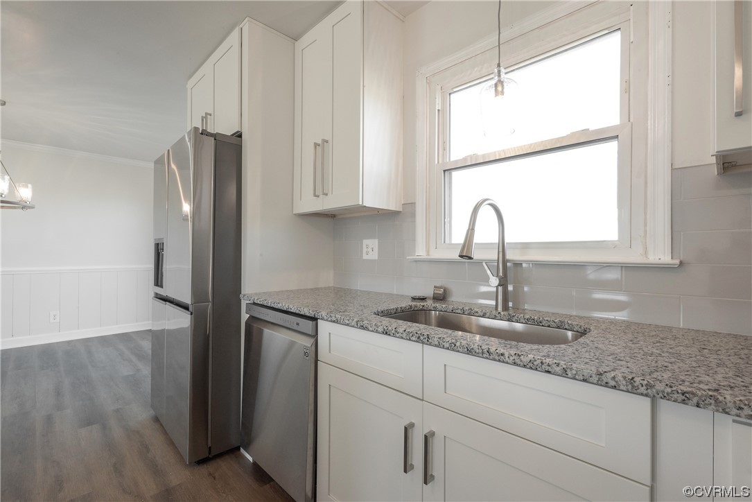 320 Courtney Road Lancaster, VA 22503 - Photo 13 of 43 a kitchen with granite countertop a sink window and cabinets
