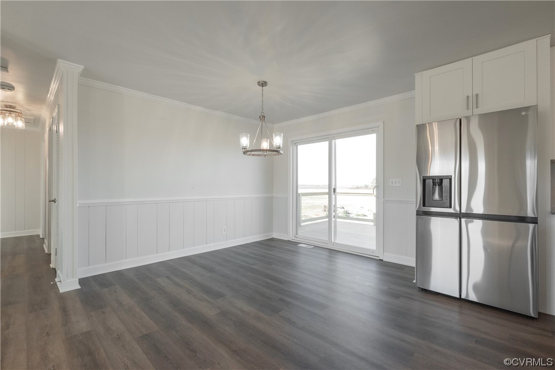 320 Courtney Road Lancaster, VA 22503 - Photo 14 of 43 a view of an empty room with wooden floor and a window