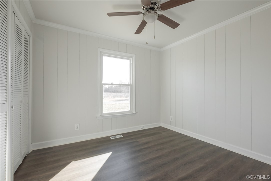 320 Courtney Road Lancaster, VA 22503 - Photo 16 of 43 an empty room with wooden floor fan and windows