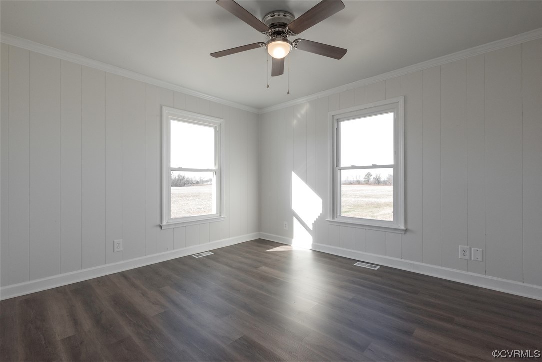 320 Courtney Road Lancaster, VA 22503 - Photo 20 of 43 a view of an empty room with wooden floor and a window
