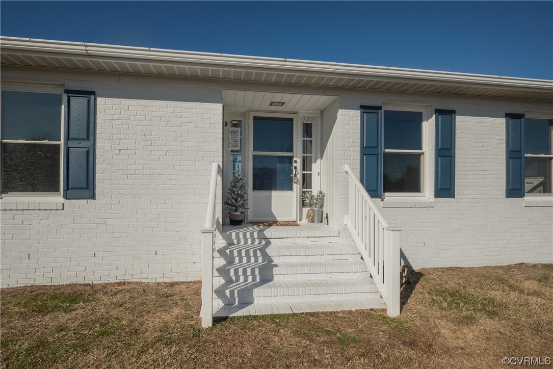 320 Courtney Road Lancaster, VA 22503 - Photo 3 of 43 a front view of a house with a porch