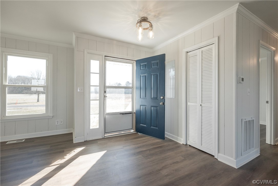 320 Courtney Road Lancaster, VA 22503 - Photo 5 of 43 a view of an empty room with wooden floor and a window