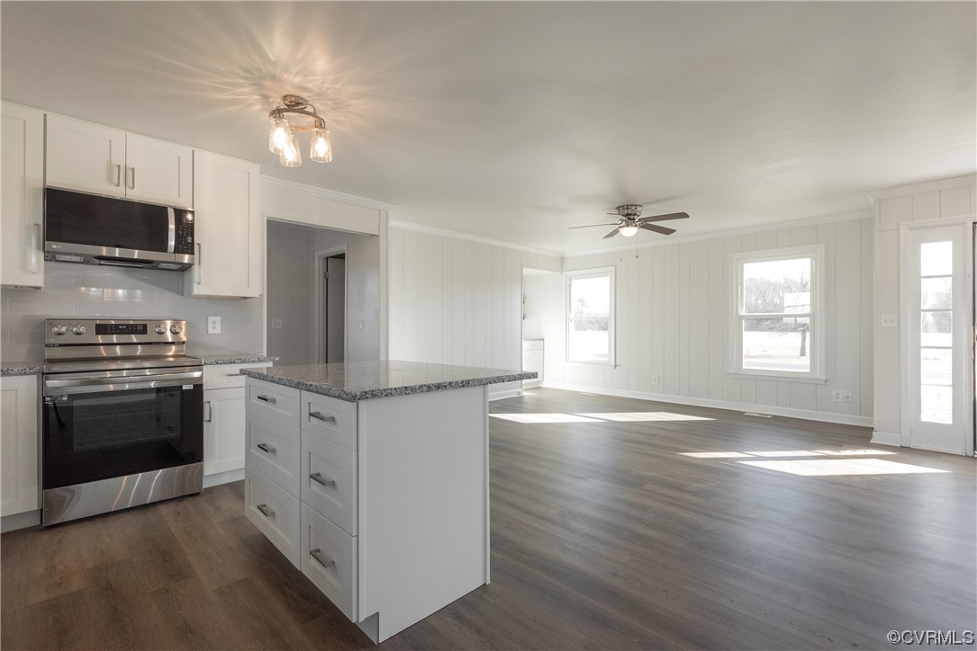 320 Courtney Road Lancaster, VA 22503 - Photo 10 of 43 a kitchen with granite countertop a stove top oven a sink dishwasher a refrigerator and a fireplace with wooden floor