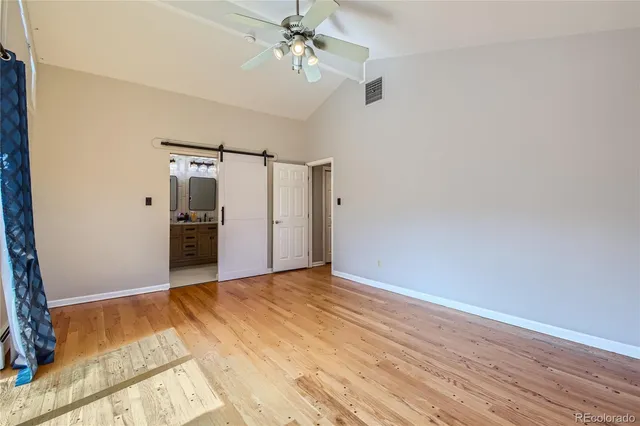 a bathroom with a granite countertop sink toilet mirror and shower