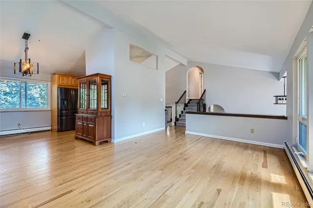 a view of a room with wooden floor and window