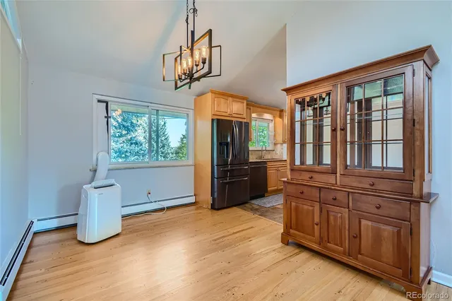 a kitchen with stainless steel appliances granite countertop a sink a stove cabinets counter space and a window