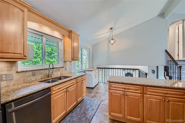 a kitchen with stainless steel appliances granite countertop a stove microwave and cabinets