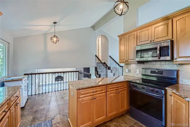 a kitchen with stainless steel appliances granite countertop a refrigerator oven a sink and dishwasher