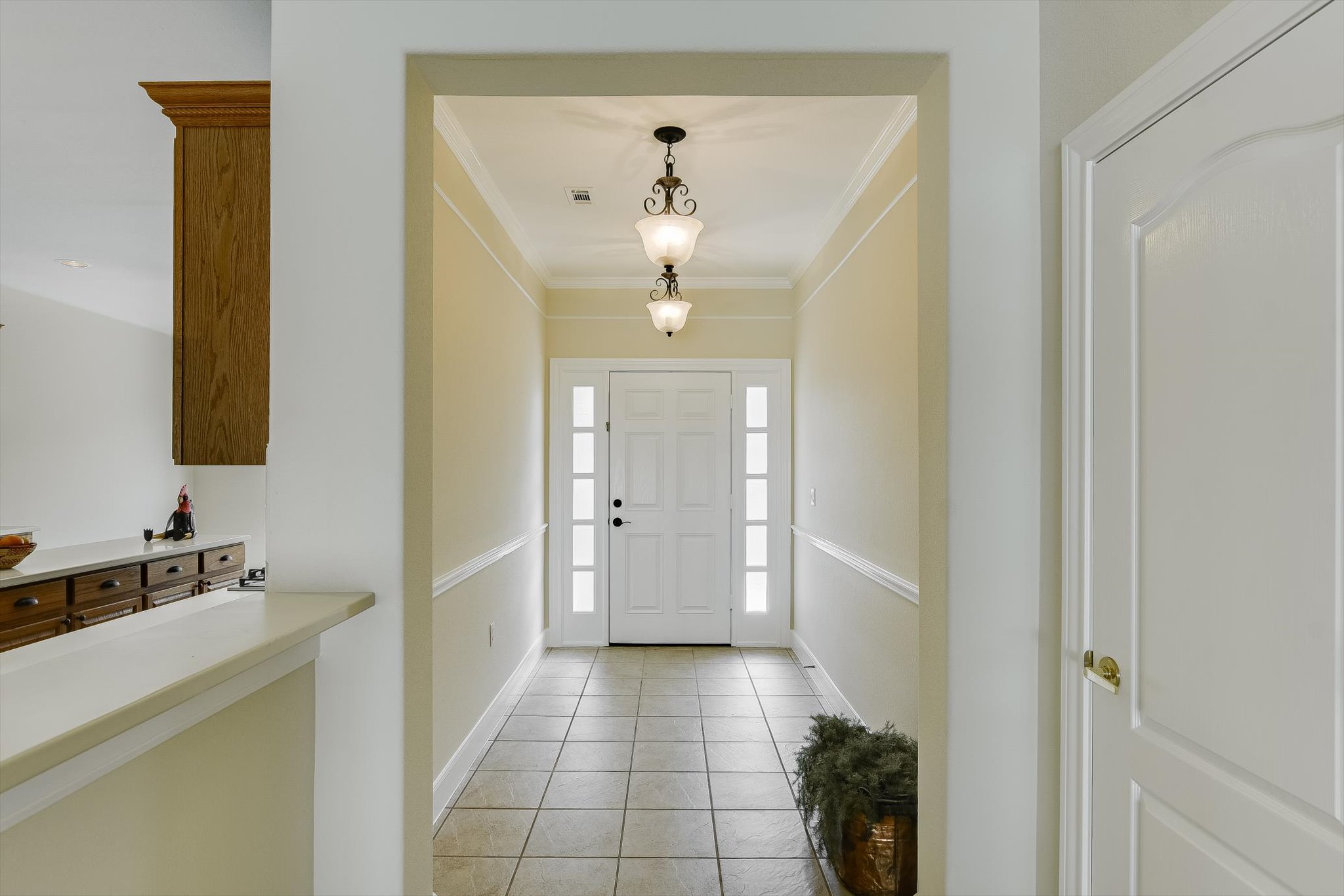 603 Rio Grande Loop Georgetown, TX 78633 - Photo 4 of 27 Foyer entrance featuring light tile patterned floors and ornamental molding