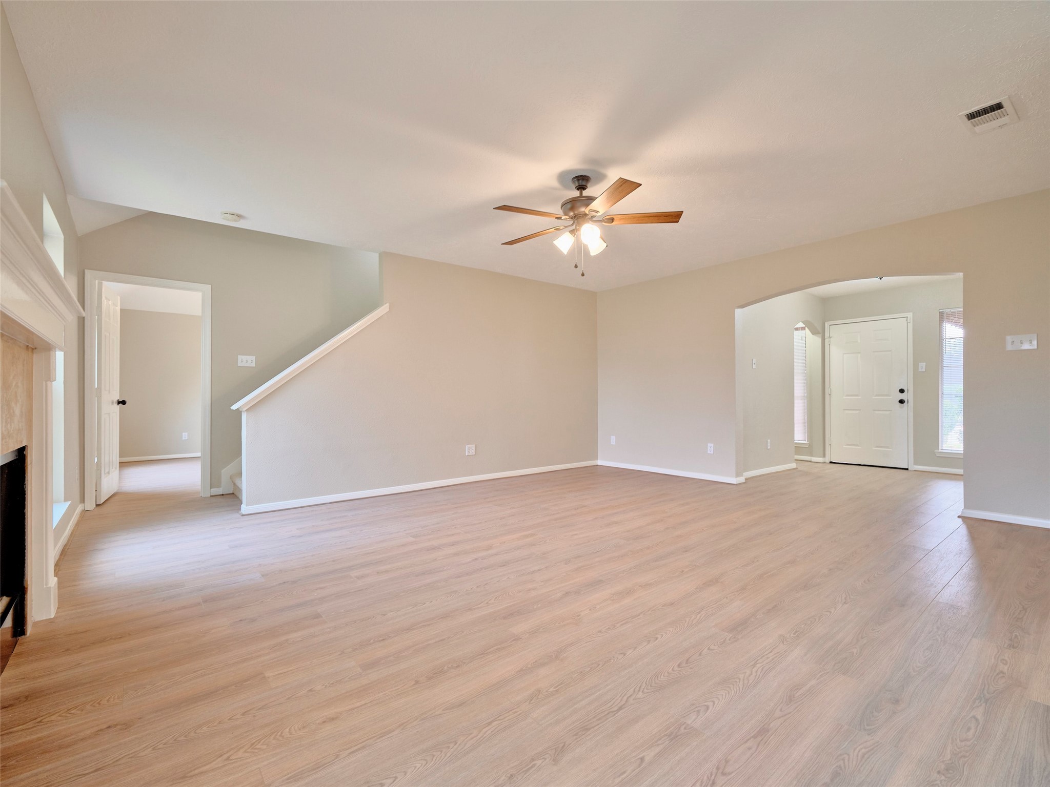 4801 East Columbary Drive Rosenberg, TX 77471 - Photo 11 of 50 a view of an empty room with a chandelier fan and a fireplace