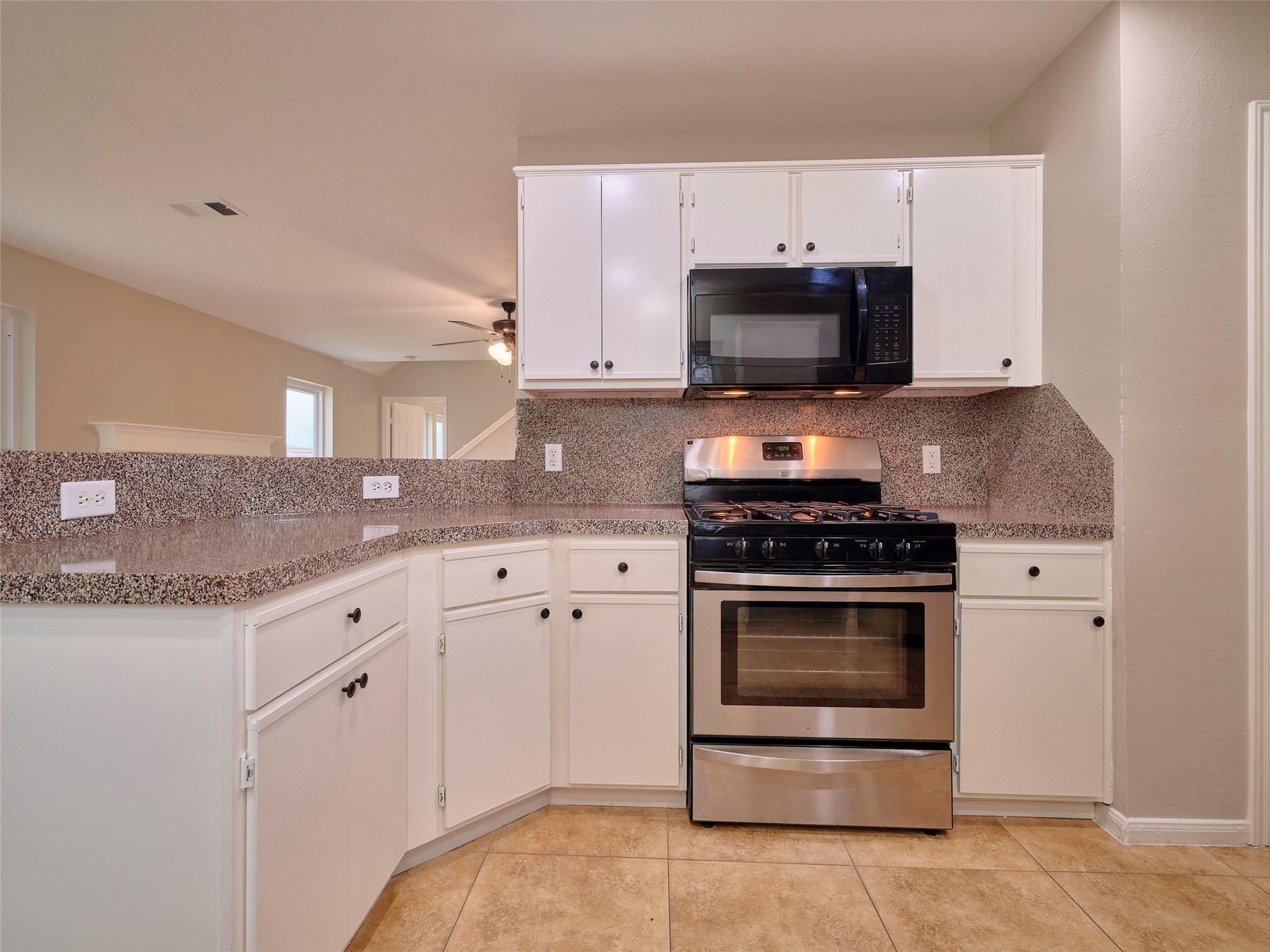 4801 East Columbary Drive Rosenberg, TX 77471 - Photo 15 of 50 a kitchen with granite countertop a stove and a sink