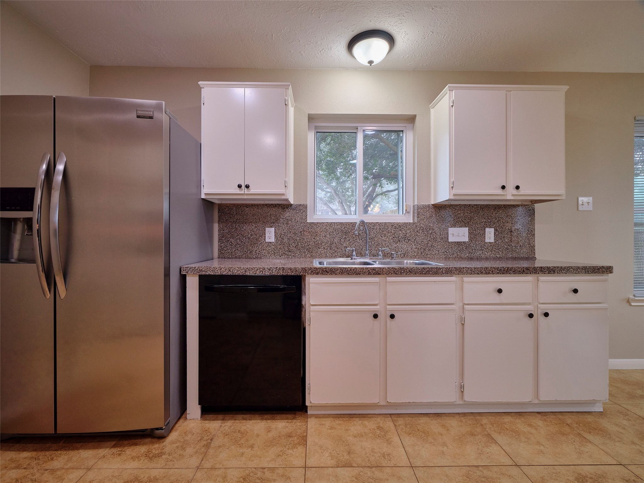 4801 East Columbary Drive Rosenberg, TX 77471 - Photo 16 of 50 a kitchen with stainless steel appliances granite countertop a refrigerator and a stove