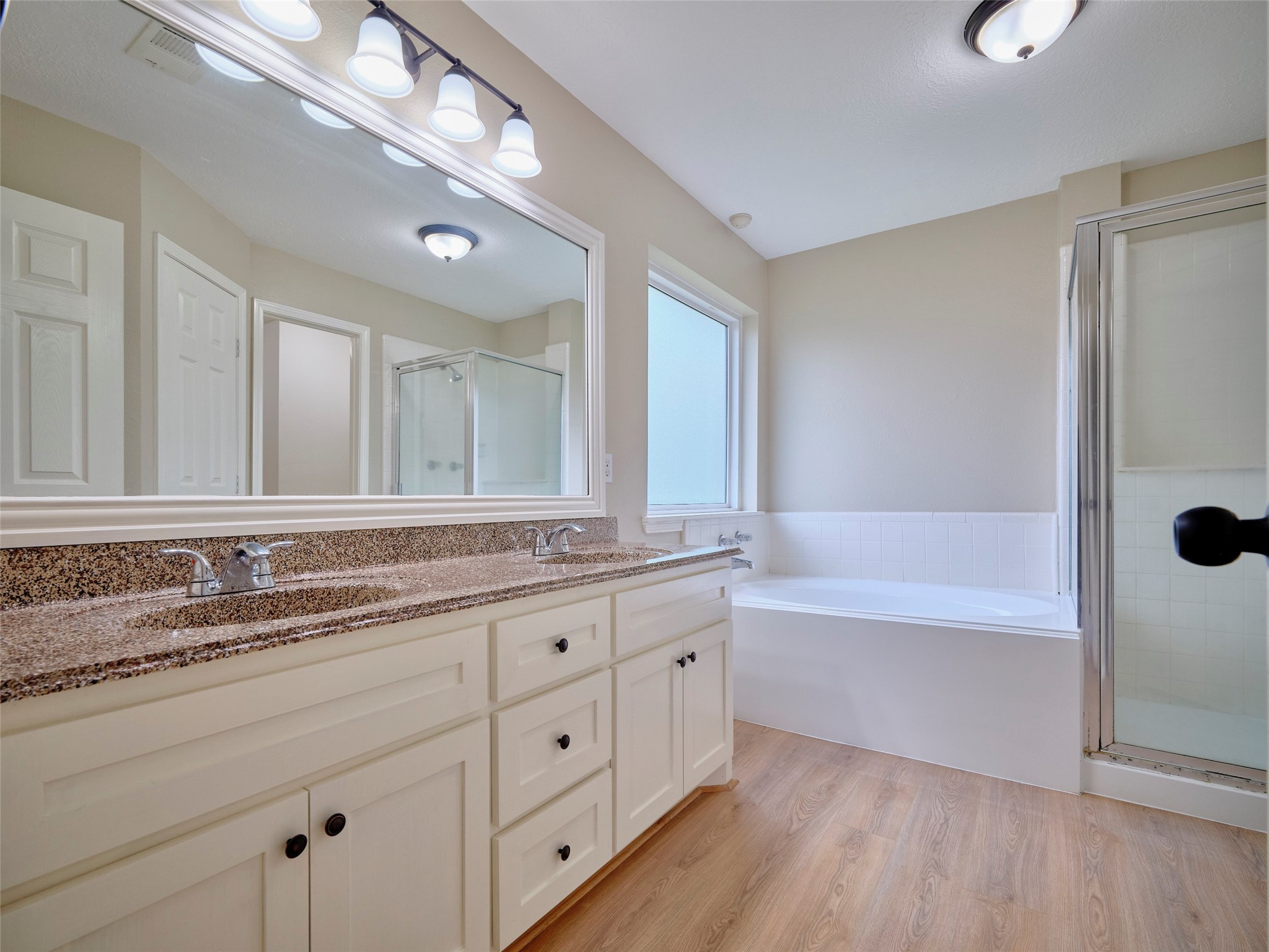 4801 East Columbary Drive Rosenberg, TX 77471 - Photo 23 of 50 a bathroom with a granite countertop double vanity sink a mirror and a bathtub with shower