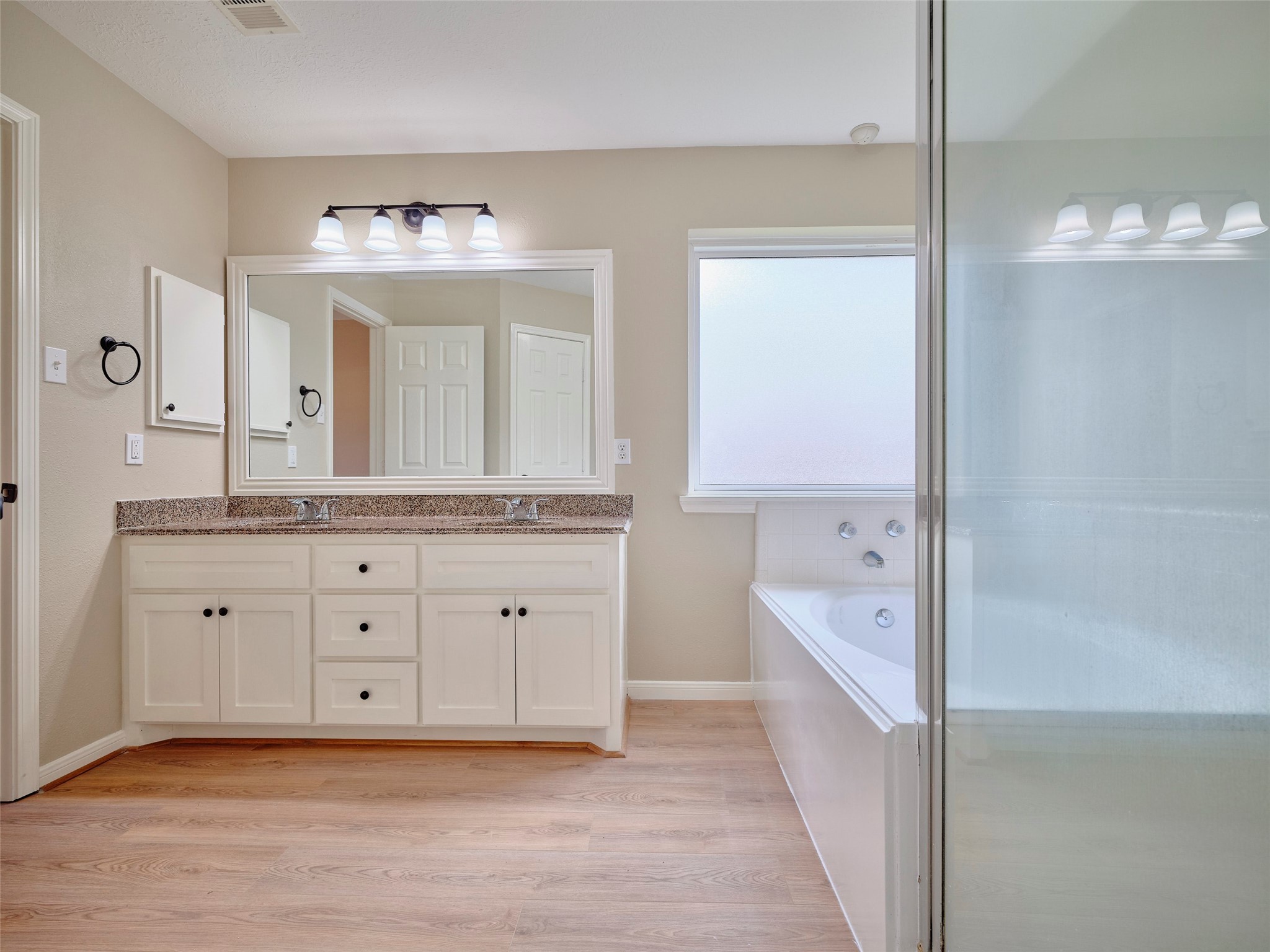 4801 East Columbary Drive Rosenberg, TX 77471 - Photo 26 of 50 a spacious bathroom with a granite countertop sink mirror and bathtub