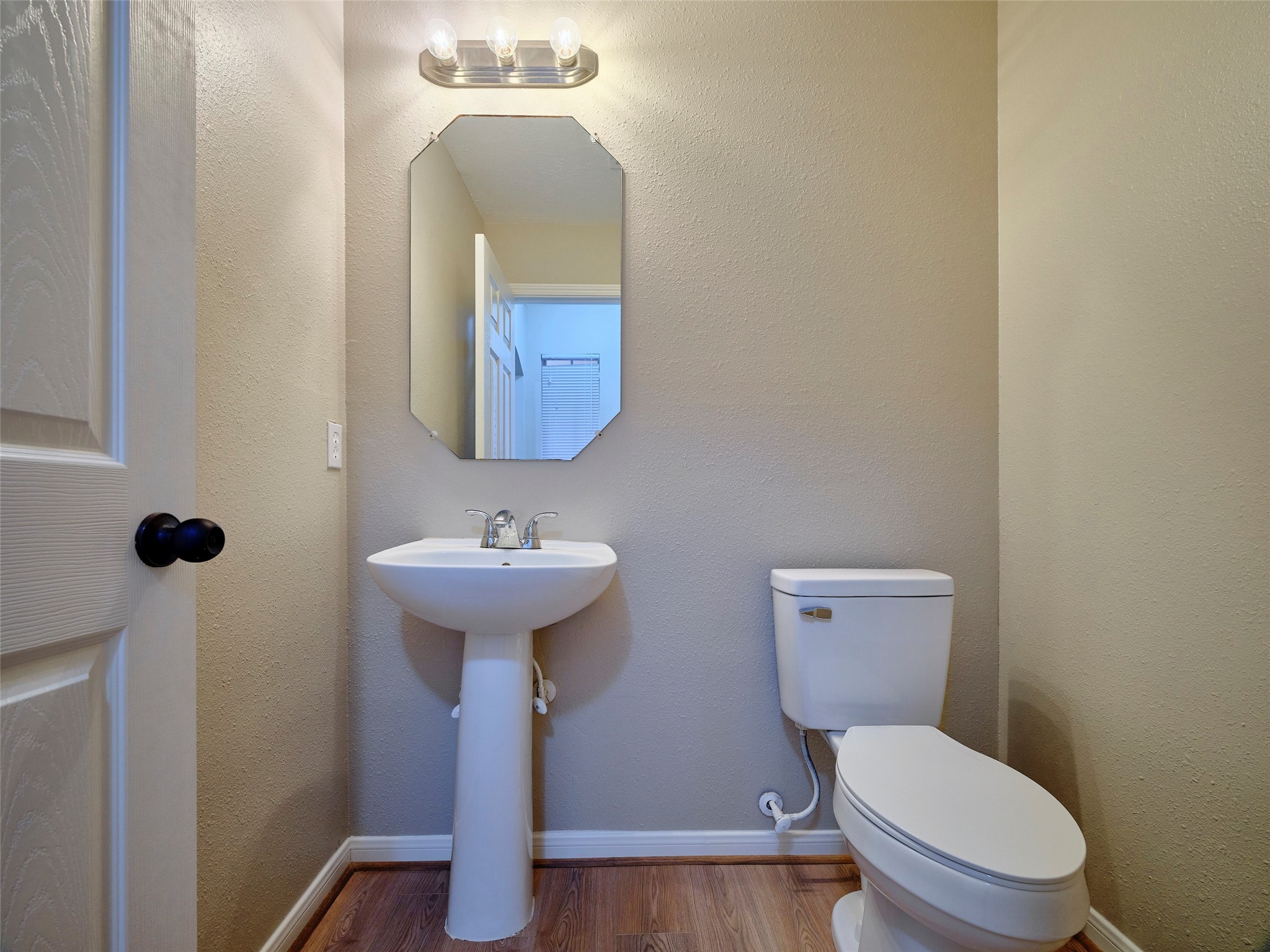 4801 East Columbary Drive Rosenberg, TX 77471 - Photo 29 of 50 a bathroom with a toilet a sink and mirror