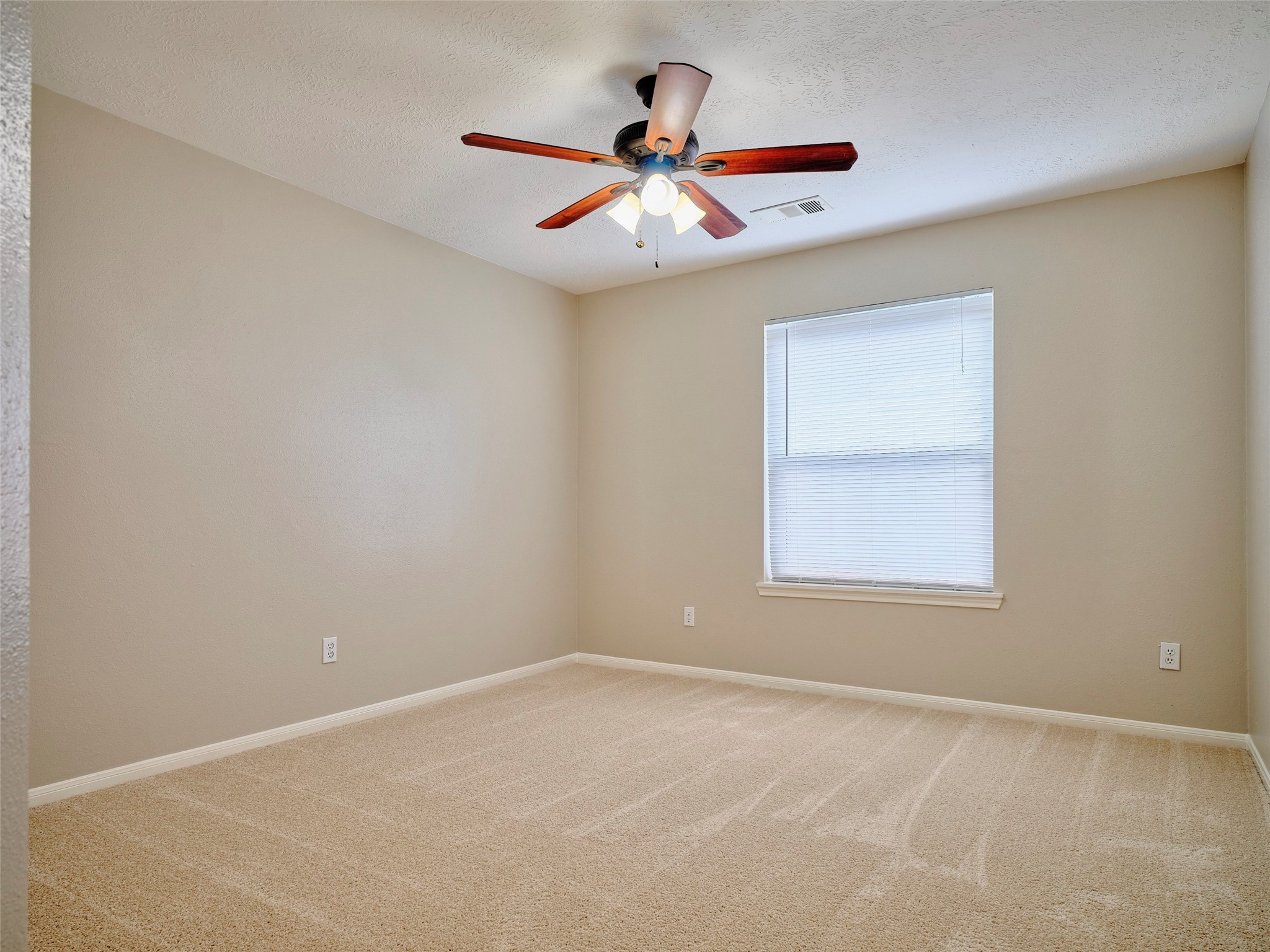 4801 East Columbary Drive Rosenberg, TX 77471 - Photo 36 of 50 an empty room with window and ceiling fan